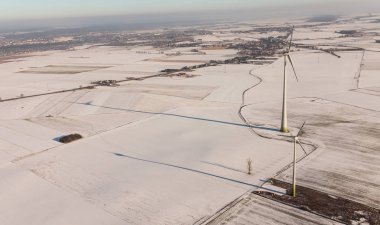 wind turbines on winter field in Poland clipart