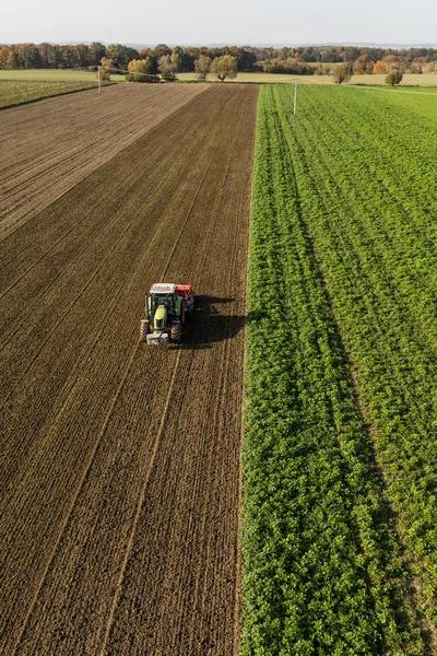 Aerial view of the tractor on the harvest field — Stock Photo, Image