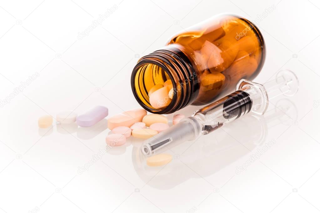 medicines pills and syringe isolated on white background