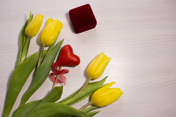 Flower tulip on white wooden background. Gift box. Bouquet of the yellow tulip flowers. Valentine\'s Day background. Valentines day concept, woman\'s day. marry me wedding engagement.