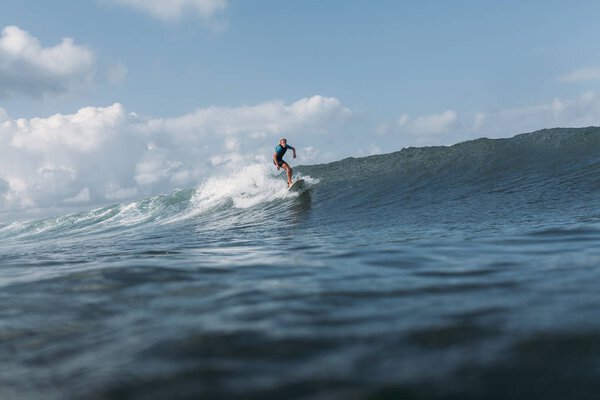 man surfing wave on surf board in ocean 