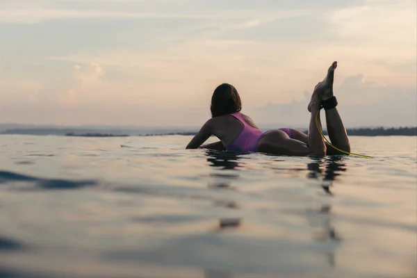 Lying on surfboard — Stock Photo, Image