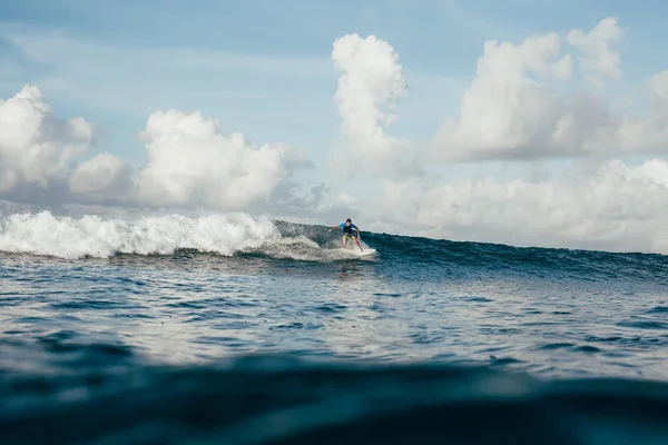 Young sportsman in wetsuit having fun on surfboard on sunny day — Stock Photo