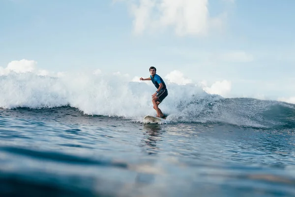 Handsome young man in wetsuit surfing on sunny day — Stock Photo