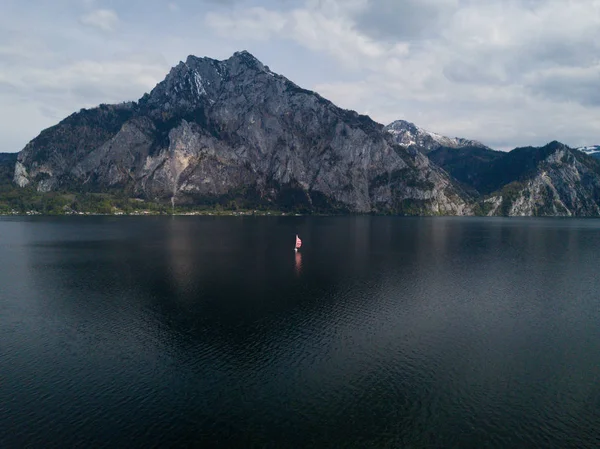 lonely boat on the beautiful lake Traunsee in austria, sailing boat, alone on the water