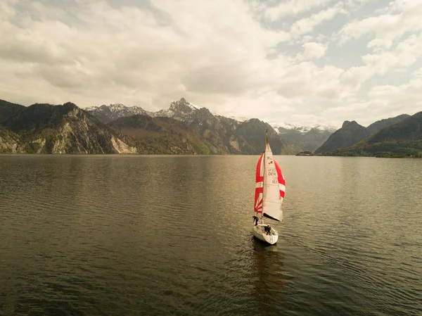 lonely boat on the beautiful lake Traunsee in austria, sailing boat, alone on the water