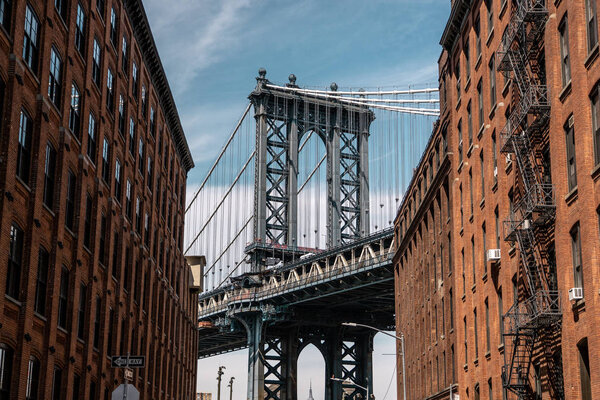 View of one of the towers of the Manhattan Bridge from the streets of the DUMBO district, Brooklyn, NYC View of one of the towers of the Manhattan Bridge from the streets of the DUMBO district, Brooklyn, NYC