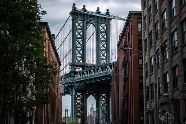 View of one of the towers of the Manhattan Bridge from the streets of the DUMBO district, Brooklyn, NYC