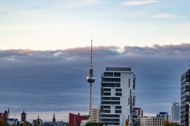 Tv tower in Berlin between some other high buildings, skyline of Berlin city Germany, river spree in Berlin with the skyline of the city in the background
