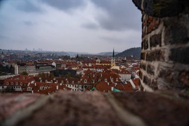 Prague from above through the wall of the castle of Prague Czech Republic, over the top of Prague, rooftops of Prague
