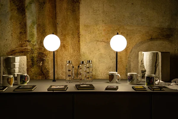 Desk with lights and books on it, great texture wall with a desk in the foreground, amazing lights on a desk full of glasses and books — 图库照片