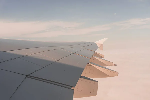 Airplane wing through the airplane window — 스톡 사진