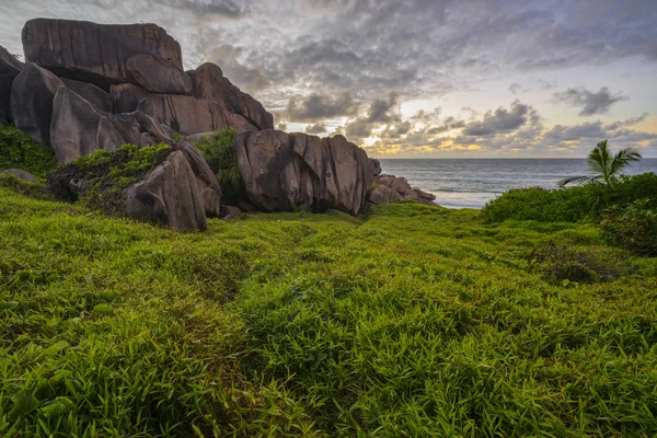 Red granite rocks in the sunrise on la digue on the seychelles 3 — Stock Photo, Image