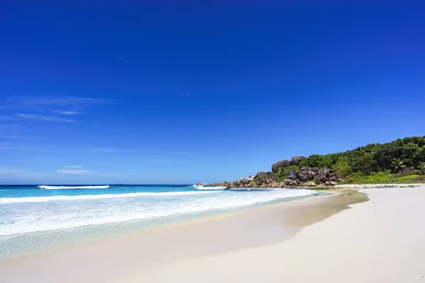 White sand, palm trees, granite rocks and turquoise water at the Stock Picture