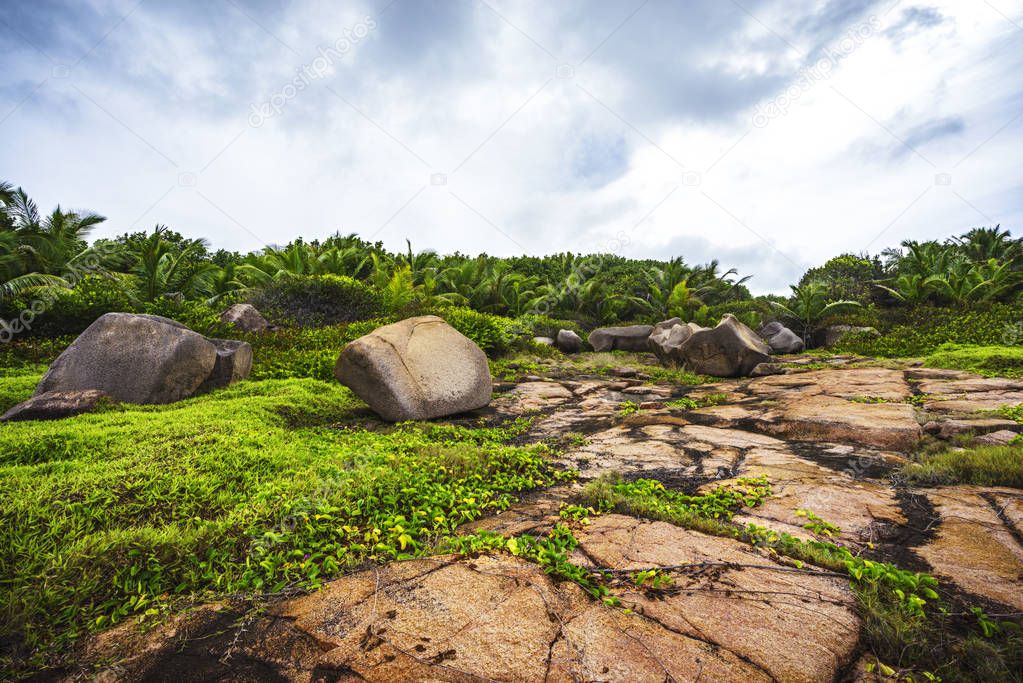Rough and wild rocky coastline at anse songe, la digue, seychell