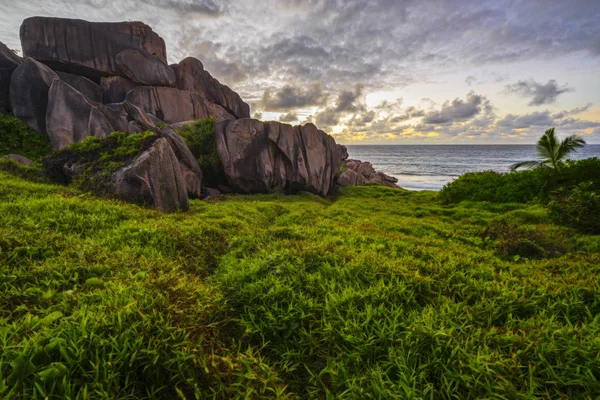 Red granite rocks in the sunrise on la digue on the seychelles 3 — Stock Photo, Image