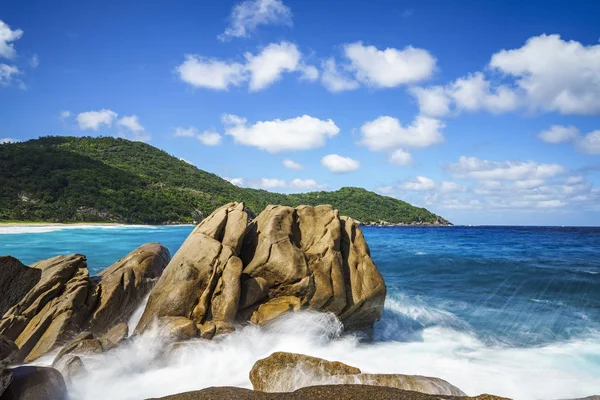 Water fountain over granite rocks,wild tropical beach with palms — Stock Photo, Image