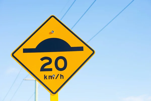Speed bump and slow down limit sign — Stock Photo, Image