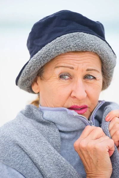 Mature woman in warm jumper in cold season — Stock Photo, Image