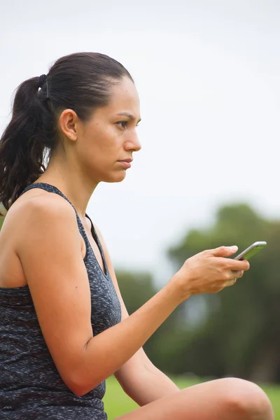 stock image Young sad woman on smart phone outdoor