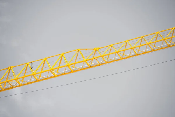 Filtered Construction crane grey sky backdrop — Stock Photo, Image