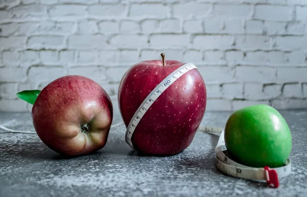 red and green apple for weight loss while dieting, centimeter measuring tape