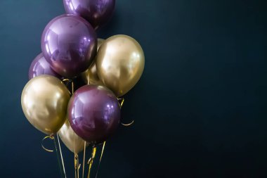 Koyu arkaplanda altın ve mor toplar var. Tatil konsepti, kartpostal.