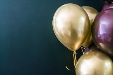 Koyu arkaplanda altın ve mor toplar var. Tatil konsepti, kartpostal.