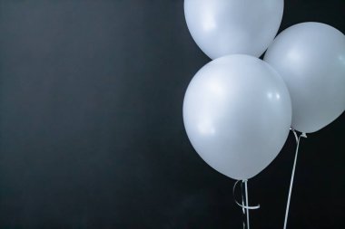 Siyah arka planda beyaz hava yuvarlak topları. Sevgililer Günü, tatil, aşk.