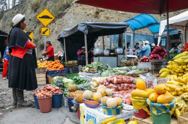Geleneksel olarak bir pazarda tropikal meyve teftiş Ekvador kadın giyinmiş