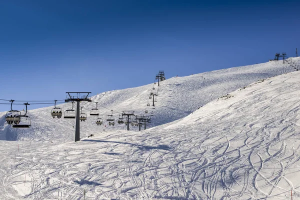Chairlift at Italian ski area on snow covered Alps during the winter — Stock Photo, Image