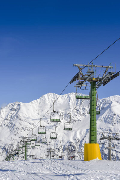 Chairlift at snow covered Italian ski area in the Alps