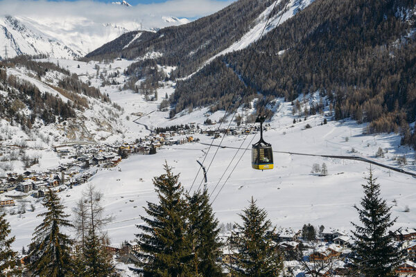 Gondola lift at ski resort in winter with copy space - La Thuile, Valle d'Aosta, Italy