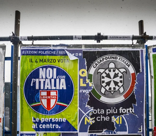 Election posters on billboard ahead of Italian General Election to be held on March 4th, 2018 - CasaPound Italy is a neo-fascist political Party next to moderate Libertas — Stock Photo, Image