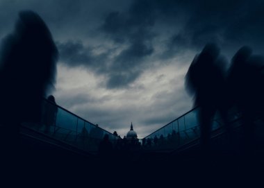Long exposure of pedestrians at London, England, UK Millenium Bridge with St. Pauls Cathedral in background - dystopia dark post-apocalyptic fine art concept. clipart