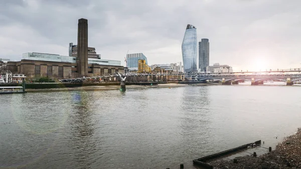 Visa från norra sidan av Themsen mot oidentifierbara fotgängare passerar Millennium Bridge leder till Tate Modern - London, England, Storbritannien. — Stockfoto