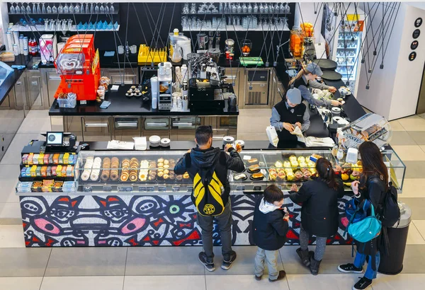 Looking down view of customers at a snack bar counter of Italian sweets — Stock Photo, Image