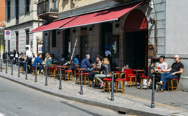 stock image People relax on a patio outside a wine bar on a hot day