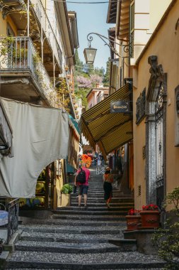 Turistler Bellagio eski kasaba merdivenlerden yukarı yürümek