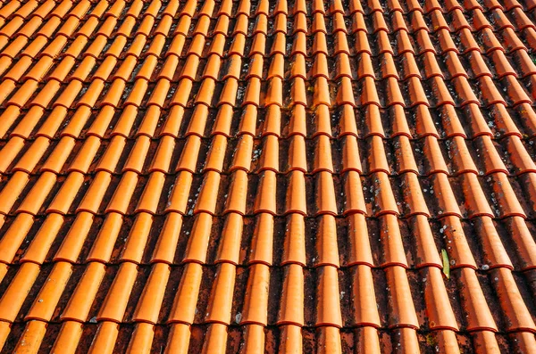 Brightly lit red tiles roof for background