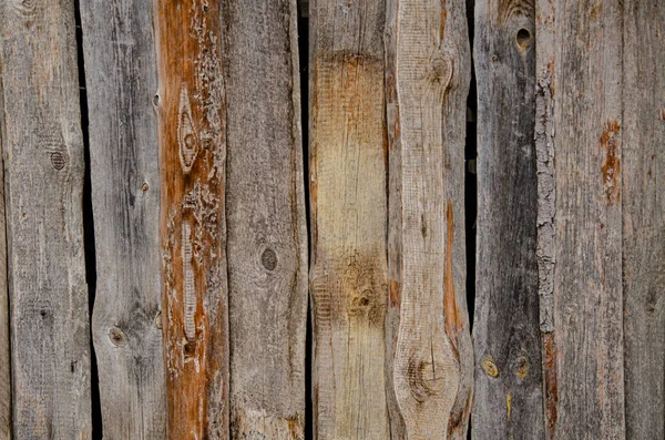 Wall of an old shed from weathered old boards. Background from old boards.
