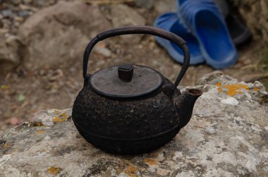 Dağlarda eski toprak, işlenmiş demir çaydanlık. Seyahat ve macera.