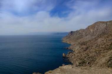 Deniz ve dağlar. Deniz Burnu Kayalık Kıyı. Güneşli bir gün.