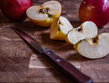 Mutfak tahtasında dilimlenmiş elma ve bıçak..