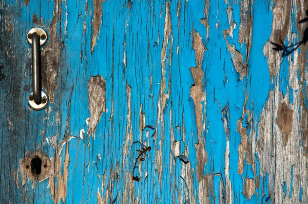 Old wooden door painted by blue paint. Background for design.