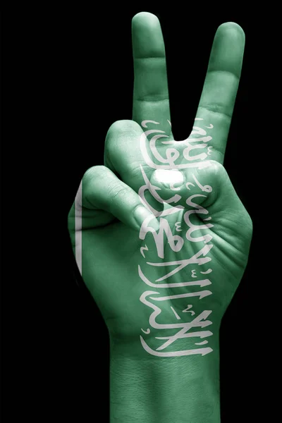 and making victory sign, Saudi arabia painted with flag as symbol of victory, win, success - isolated on black background
