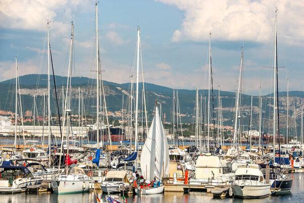 Muggia, Italy - Circa August 2018. Sunny day in harbor. View of yachts moored in a small coastal town Muggia.