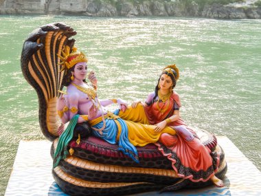 Rishikesh, India - Circa March 2018. Beautiful statues of Lord Vishnu and Lakshmi at the Ganga riverbank in Rishikesh.