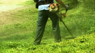 Çim biçme makinesi işçisi adam kesme çim yeşil alanda yakın çekim