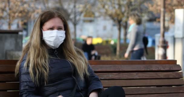 Woman Mask Protection Corona Virus Sits Bench Talks Phone — Stock Video